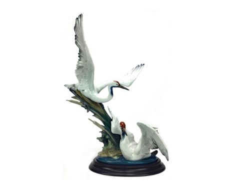 LLADRO FIGURE GROUP OF CRANES, modelled amongst reeds, one taking flight, printed mark to base, 52cm high, with wooden plinth