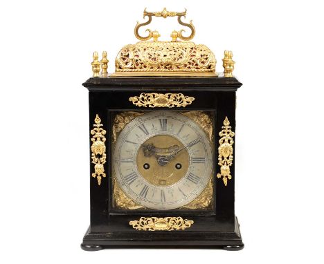 WILLIAM SPEAKMAN, LONDON A WILLIAM AND MARY EBONISED GILT BRASS MOUNTED BASKET TOP BRACKET CLOCK the gilt embossed figural sc