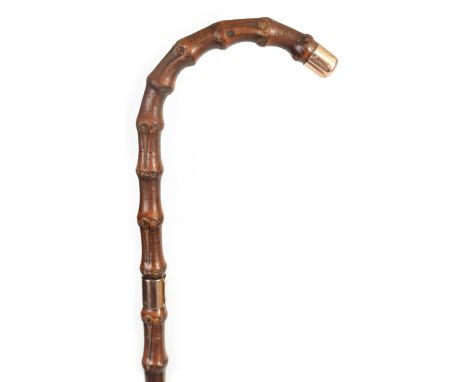 A LATE 19TH CENTURY 9CT GOLD TIPPED BAMBOO WALKING STICK BY BRIGG with hooped handle and rose gold tip and collar, initialled