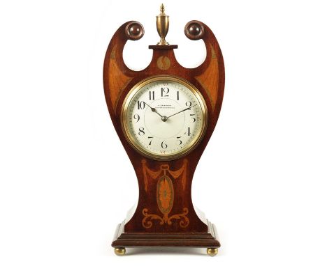 AN EDWARDIAN ART NOUVEAU STYLE BOXWOOD STRUNG AND MAHOGANY INLAID MANTEL CLOCK with swan-neck top and brass centre finial, th