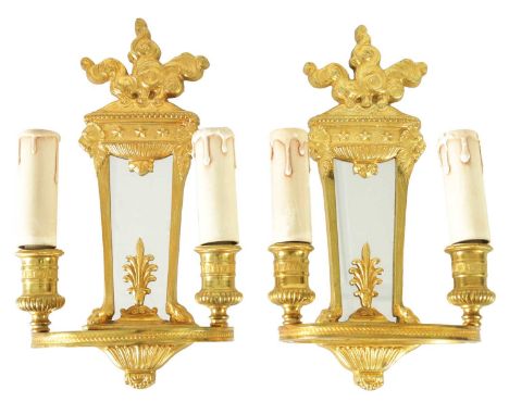 A PAIR OF ORMOLU REGENCY STYLE TWO BRANCH WALL LIGHTS with tapering mirrored backs and ringed light fittings.29cm high 16cm w