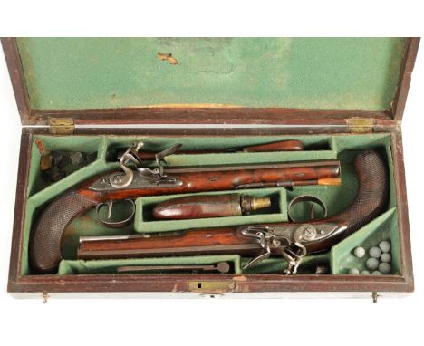 WOGDON, LONDON. A FINE CASED PAIR OF EARLY 19TH CENTURY FLINTLOCK DUELLING PISTOLS the octagonal browned Damascus barrels sig