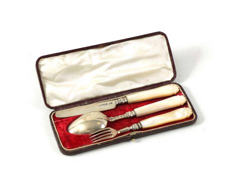 A VICTORIAN 3 PIECE CASED SET OF SILVER CHILD'S CUTLERY comprising knife, fork and spoon with scroll-carved mother-of-pearl h