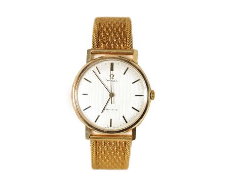 A GENTLEMAN’S 9CT GOLD OMEGA WRISTWATCH ON 18CT GOLD BRACELET the brushed silvered dial with gold baton hour markers and swee