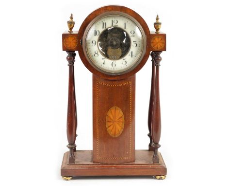 AN EARLY 20TH EUREKA CENTURY ELECTRIC MANTEL CLOCK the mahogany inlaid case with four baluster pillars enclosing a skeletonis