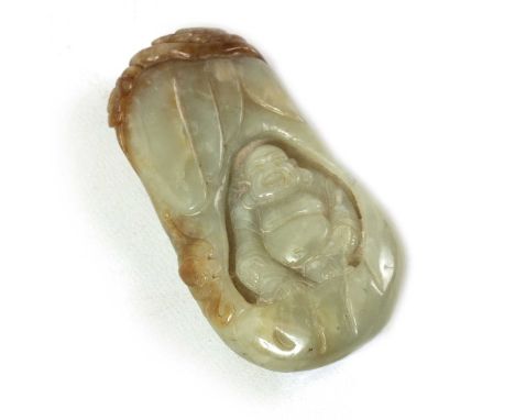 A CHINESE CARVED JADE SCULPTURE modelled as a seated Buddha with russet inclusions to the top10cm high 