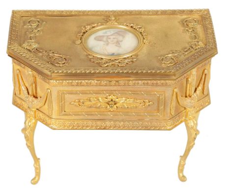 A 19TH CENTURY FRENCH ORMOLU JEWELLERY CASKET of clipped rectangular form on slender cabriole legs with cast leafwork borders