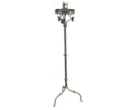 A 17TH CENTURY CAST IRON STANDING PRICKET STICK with gothic style frieze above a knopped stem and triform leg base142cm high 