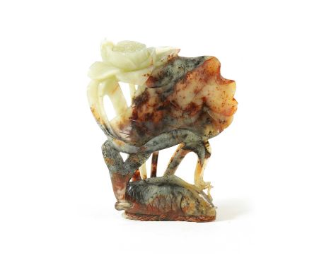 A LARGE CHINESE CARVED AND PIERCED JADE SCULPTURE of varying colours modelled as a fish amongst flowers and a lily pad19cm hi