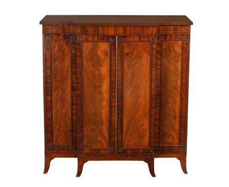A GOOD REGENCY FLAME MAHOGANY AND BRASS INLAID BREAKFRONT BOOKCASE in the manner of Gillows with brass inlaid frieze above pa