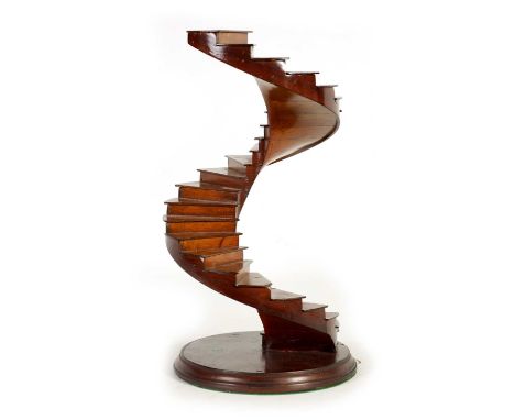 A 20TH CENTURY MAHOGANY FRENCH MODEL OF A SPIRAL STAIRCASE mounted on circular moulded edge plinth base.36cm high