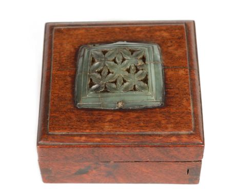 AN EARLY CHINESE JADE PLAQUE MOUNTED ON LATER BOX of square form finely pierced and carved in a leafwork design within a moul