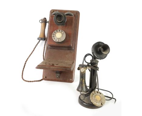 TWO EARLY 20TH CENTURY TELEPHONES one wall mounted in a mahogany case, the other stick phone with Bakelite mouth piece (2)Wal