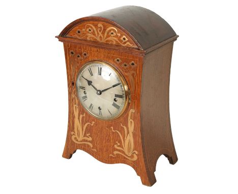 A GERMAN ART NOUVEAU OAK CASED INLAID QUARTER CHIMING BRACKET CLOCK with arched moulded pediment above a concaved sided case 