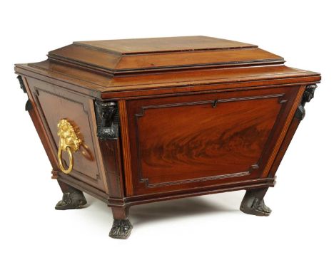 A GOOD REGENCY INLAID FLAME MAHOGANY SARCOPHAGUS WINE COOLER with flat hinged moulded edge top revealing a lead lined interio