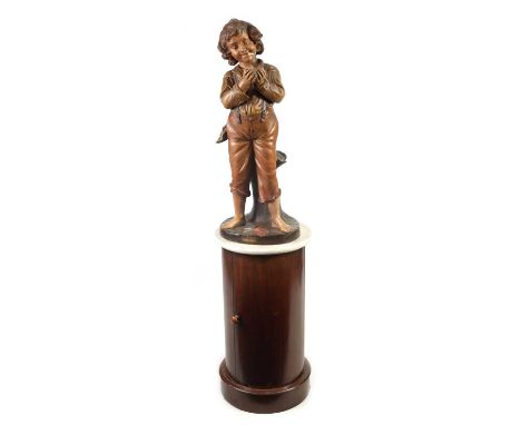 AN EARLY 20TH CENTURY POLYCHROME TERRACOTTA ADVERTISING FIGURAL LAMP ON ASSOCIATED STAND modelled as a boy lighting a cigaret