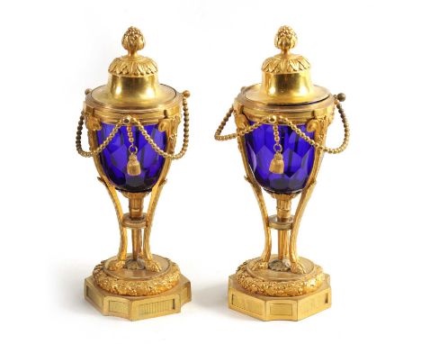 A FINE PAIR OF REGENCY FRENCH ORMOLU AND BLUE GLASS REVERSIBLE CASOLETTES with changeable urn and candlestick tops above cut 