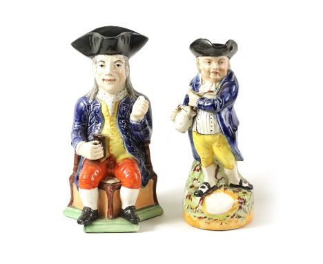 A 19TH CENTURY STAFFORDSHIRE ‘ENGLISH SQUIRE’ TOBY JUG' AND ANOTHER 'HEARTY GOOD FELLOW' TOBY JUG the proudly seated gentlema