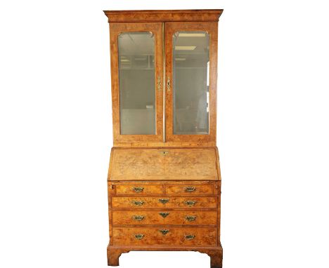 A GOOD QUEEN ANNE BURR WALNUT AND HERRING-BANDED BUREAU BOOKCASE the moulded cothice above mirrored doors revealing a shelved