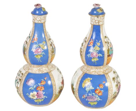 A PAIR OF LATE 19TH CENTURY DRESDEN TYPE AUGUSTUS REX TAPERING DOUBLE GOURD BOTTLE VASES AND COVERS the gilt-edged bodies wit