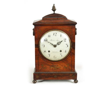 THOMAS JONES, LONDON. A REGENCY BRASS INLAID MAHOGANY BRACKET CLOCK with chamfered top and pineapple finial on a rectangular 