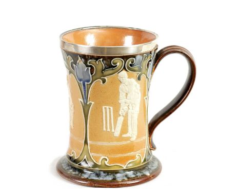 A LATE 19TH CENTURY DOULTON LAMBETH STONEWARE CRICKET MUG with silver rim above a panelled body depicting cricket scenes surr