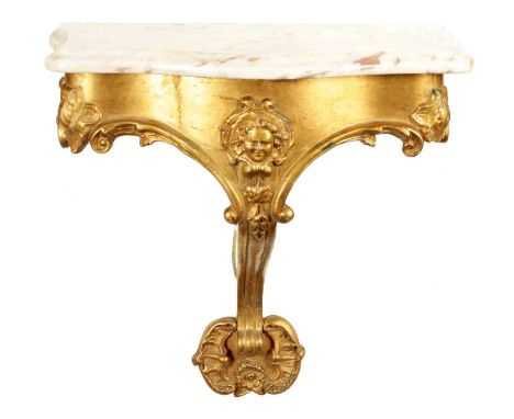 AN 18TH CENTURY FRENCH CARVED GILT WOOD HANGING CONSOLE TABLE with serpentine shaped marble top above a mask head leaf moulde