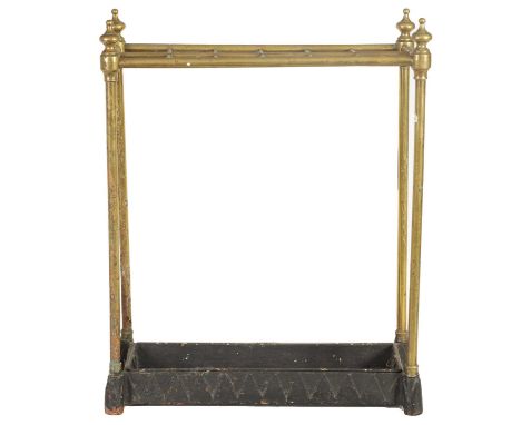 A LATE 19TH CENTURY BRASS AND CAST IRON STICK STAND fitted a 12 sectioned top on four brass stems with turned finials on a ca