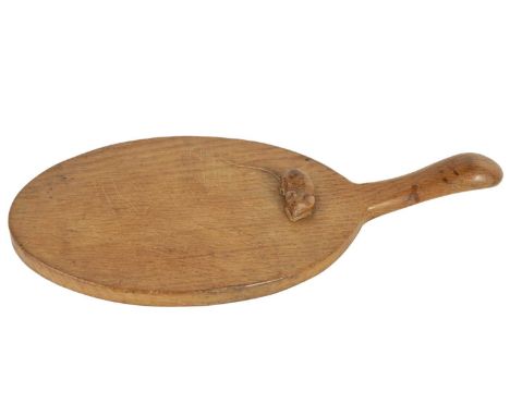 A ROBERT ‘MOUSEMAN’ THOMPSON LIGHTLY ADZED OAK CHEESE BOARD of oval form with raised handle and carved mouse motif to the bod