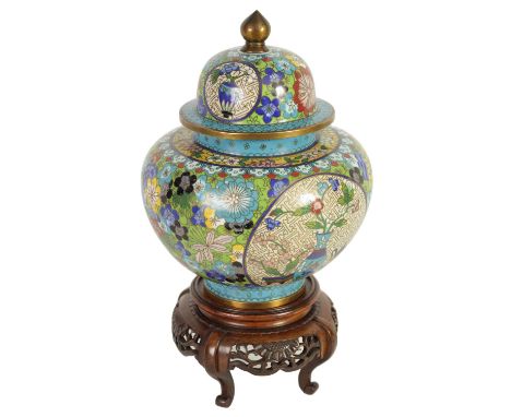 A LATE 19TH CENTURY CHINESE CLOISONNÉ ENAMEL JAR AND COVER ON CARVED WOOD STAND of tapering shouldered form with domed lid an