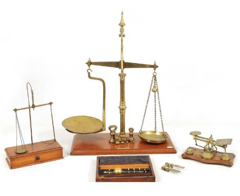 A COLLECTION OF 19TH CENTURY WEIGHING SCALES the largest set of shop scales and bell weights labelled Bartlett &amp; Son Ltd.