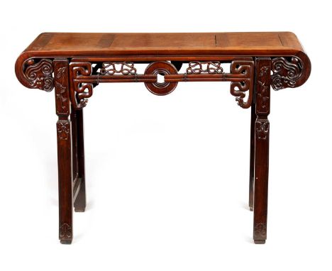 A 19TH CENTURY CHINESE HARDWOOD ALTAR TABLE with panelled top and scrolled carved sides joined by a decorative fret cut friez