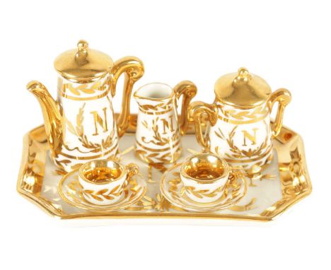 AN EARLY 20TH CENTURY MINIATURE LIMOGES PORCELAIN FRENCH NAPOLEON TEA SERVICE comprising coffee can, sugar bowl, jug, rectang