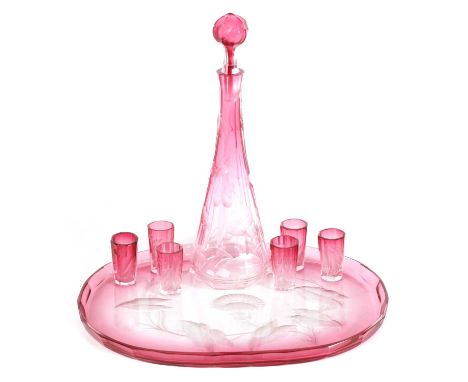 AN ART NOUVEAU RUBY AND CLEAR GLASS MOSER DECANTER, TRAY AND SIX GLASSES deeply cut with intaglio decoration to each piece.de