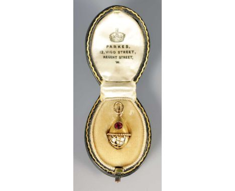 A LATE 19TH CENTURY FABERGE 14CT GOLD ENAMEL AND RUBY PENDANT EGG, WORKMASTER HENRIK WIGSTROM the egg with rose cut ruby abov