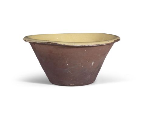 A LARGE POTTERY BOWL,of tapered circular form, with out-turned rim, the bowl with yellow enamel. 47.5cm diameter