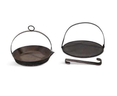 TWO IRON CIRCULAR SKILLET BASES,one with fixed handle and the other with swing handle, 36cm diameter and 31cm diameter respec