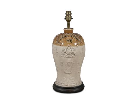 A VICTORIAN GLAZED EARTHENWARE FLAGON,with cast decoration and inscribed 'O'Connor Brothers, Sligo 1869', converted to a tabl