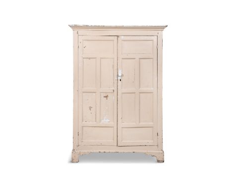 AN EARLY 19TH CENTURY WHITE PAINTED PINE CABINETthe moulded cornice above two long cupboard doors each with six panels, the s