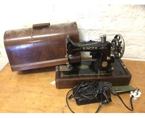 A Singer table top sewing machine with motor inscribed sewing motor catalogue BUK12-E along with light inscribed Singer and e