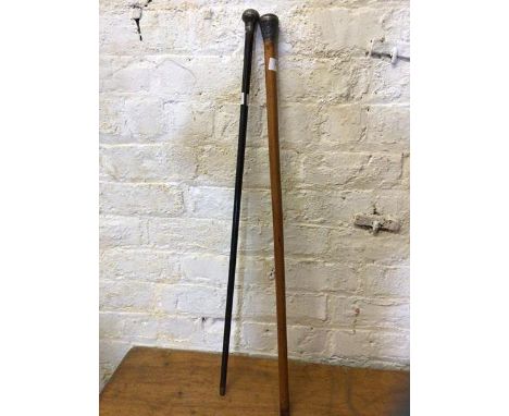 A malacca walking stick with white metal knop, measures 92cm and another walking stick ebonised with white metal knop (2)