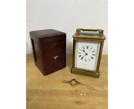 A four glass carriage clock inscribed to dial McDowell Bros Dublin measures 19cm high with handle along with a travelling cas