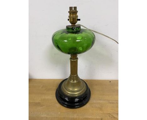 An Edwardian oil lamp with green glass reservoir on brass column style base later converted for electricity measures 38cm hig