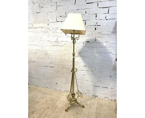 An Edwardian telescopic brass standard lamp with scrolled decoration and square tapered shade, H150cm