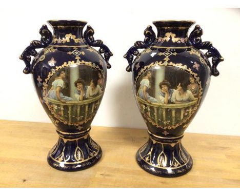 A pair of Royal Limoges early 20thc baluster shaped vases with handles to sides and matching panels to one side depicting lad