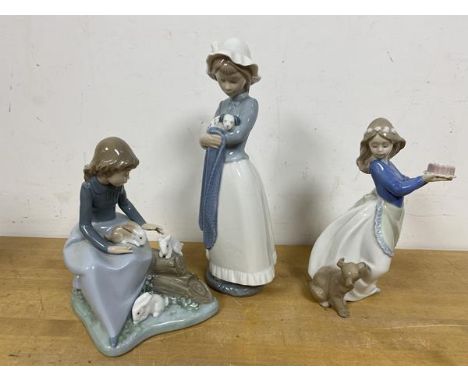 Three Nao figures of young girls with animals, tallest measures 26cm high (3)