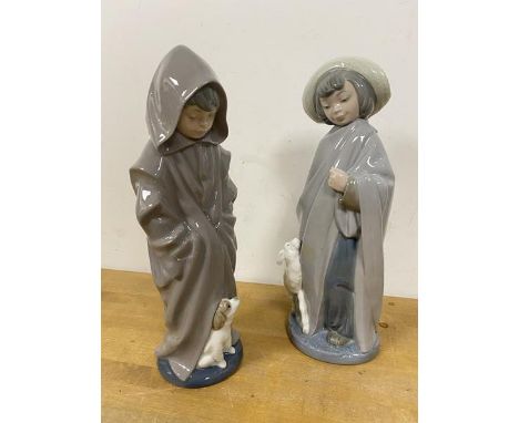 Two Nao figures each of a young child in raincoat with animals measure 27cm high (2)