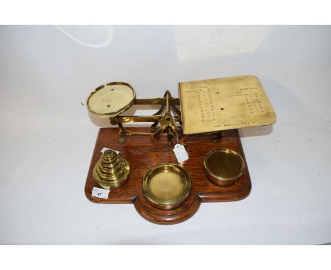 VICTORIAN PARCEL SCALES WITH ACCOMPANYING WEIGHTS, SET ON A WOODEN BASE