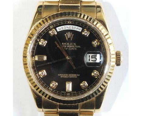 A gentleman's 18ct gold Rolex Oyster Day-Date wrist watch c2008, the fluted bezel enclosing a black dial with baguette diamon