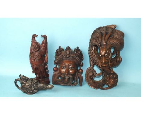 A carved wood Chinese wall hanging in the form of a dragon, 26cm high, another in the form of a mask and a 20th century bronz